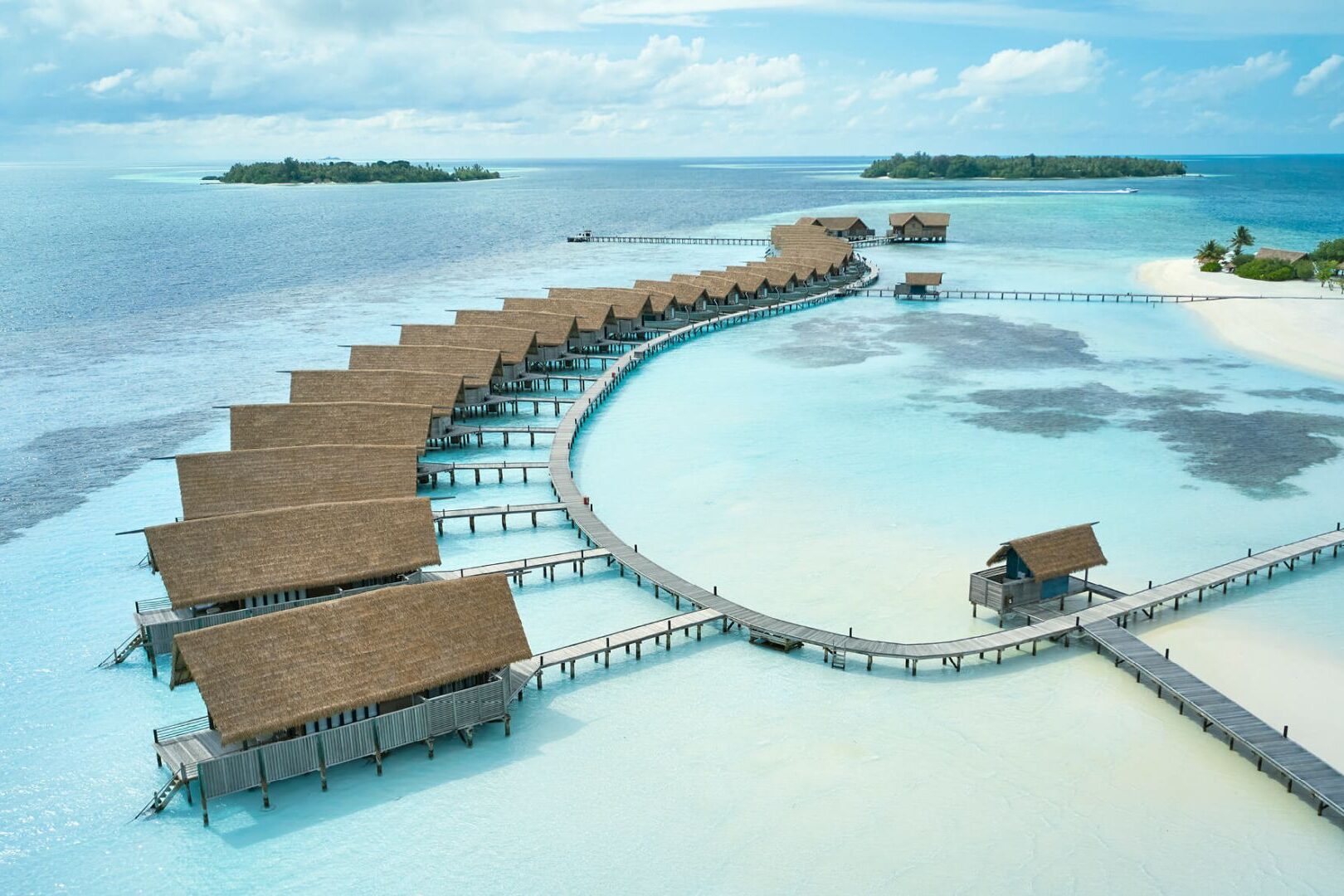 Long line of overwater bungalows and villas at COMO Cocoa Island