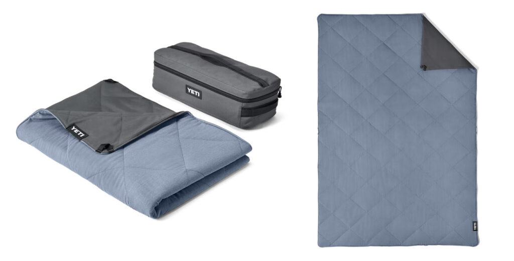 Multiple views, folded and laid flat, of the YETI Lowlands Waterproof Outdoor Blanket in Navy Blue
