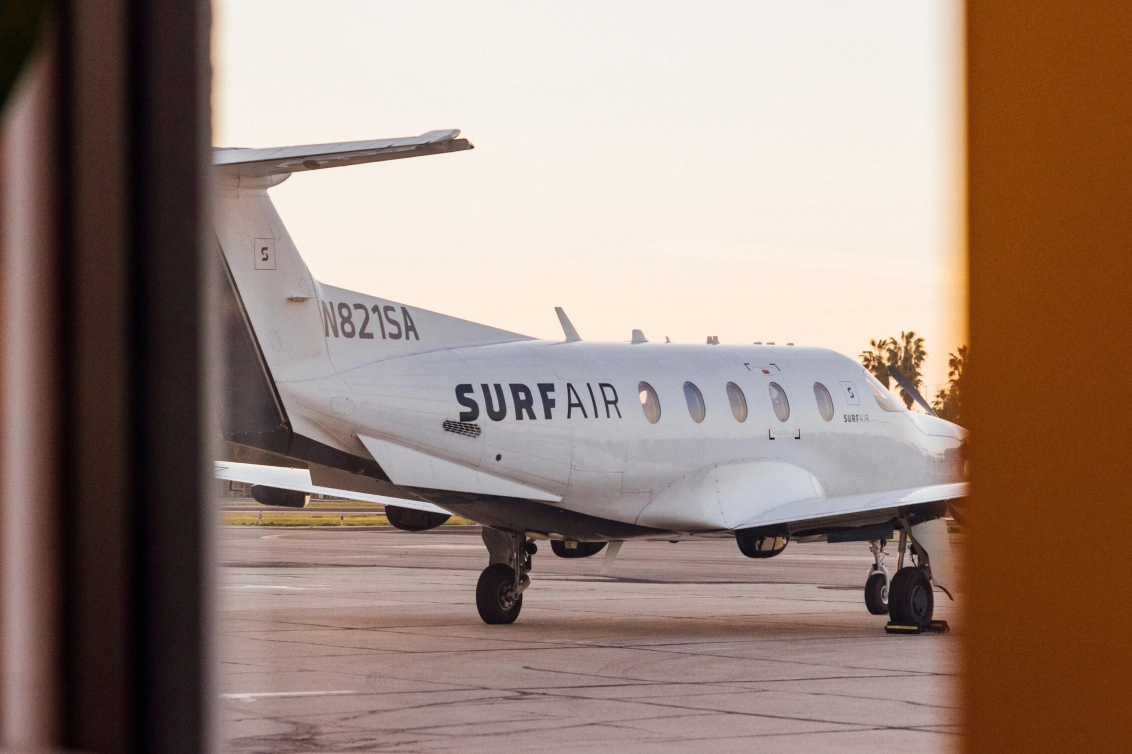A SurfAir semi-private jet as seen through an opening in a door