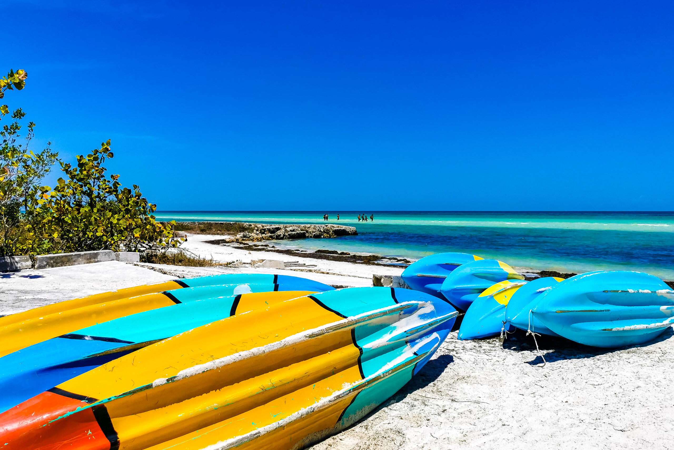 Colorful canoes pulled up on the beach in Holbox, Mexico