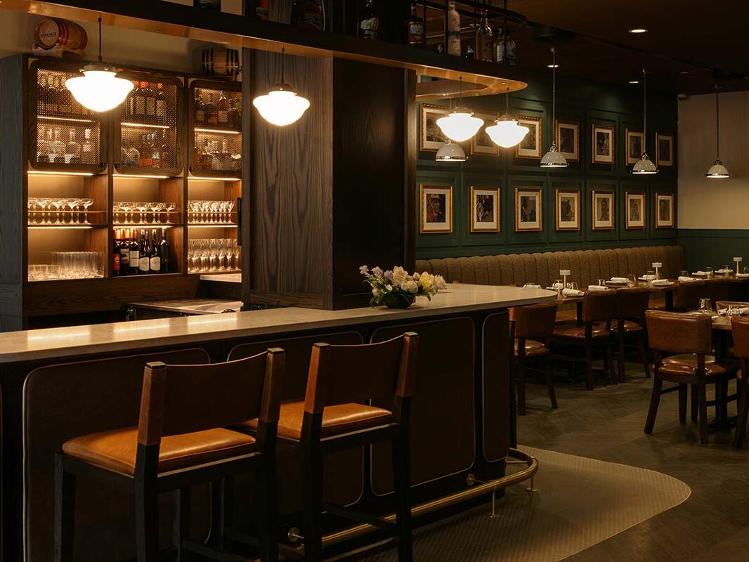 Low lit bar in Brazen, the main restaurant at the Mount Royal Banff historic hotel in Banff, Alberta, Canada