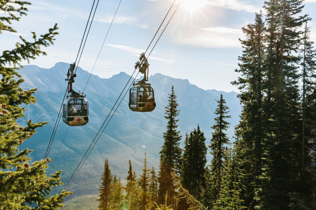 Gondolas going up the side of Sulphur Mountain in Banff, Canada on a sunny day