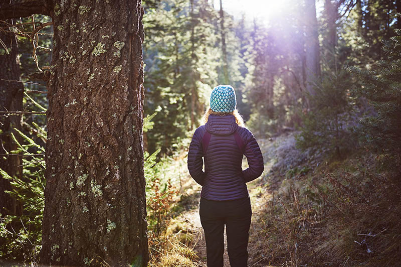 Woman walking through a warmly lit forest