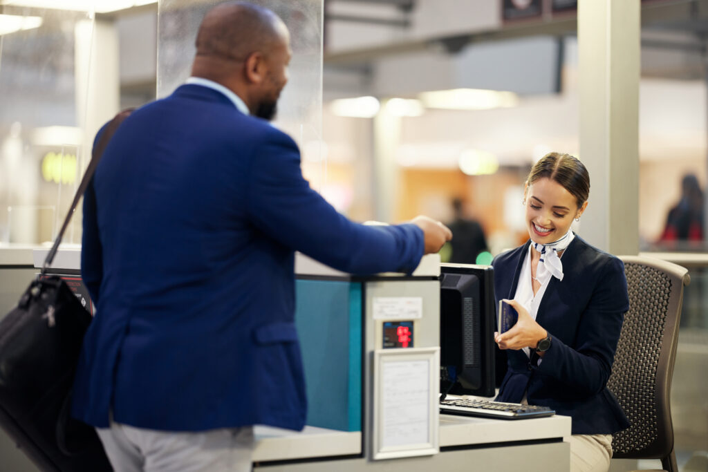 Traveler handing passport to security agent in airport