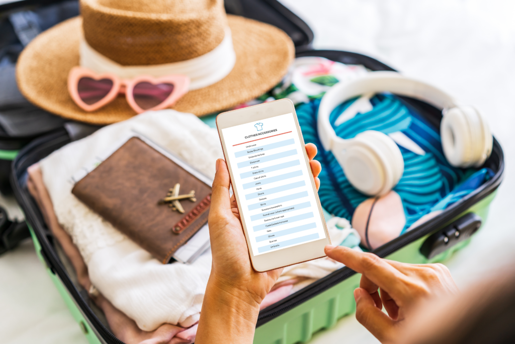 Close up of person reading the SmarterTravel Ultimate Packing List on their phone while packing a suitcase