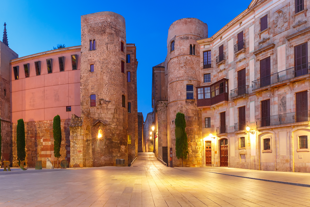 Panorama of Ancient Roman Gate and Placa Nova during morning blue hour, Barri Gothic Quarter in Barcelona, Catalonia, Spain