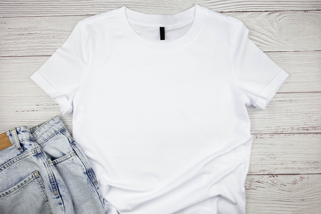White womens cotton Tshirt mockup with blue jeans pants on wooden background. Design t shirt template, print presentation mock up. Top view flat lay.