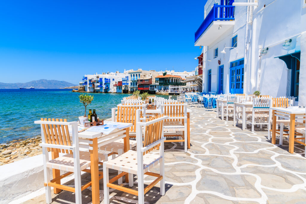 Outdoor dining patio along the coast of the Greek island of Mykonos