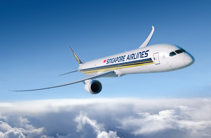 A Singapore Airlines aircraft flying through a blue sky