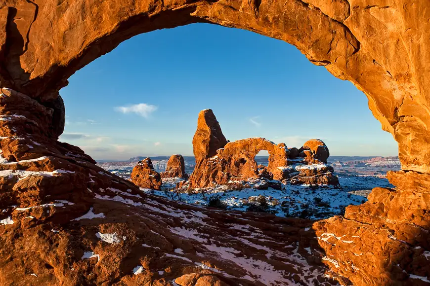 First light on turret arch framed by north window