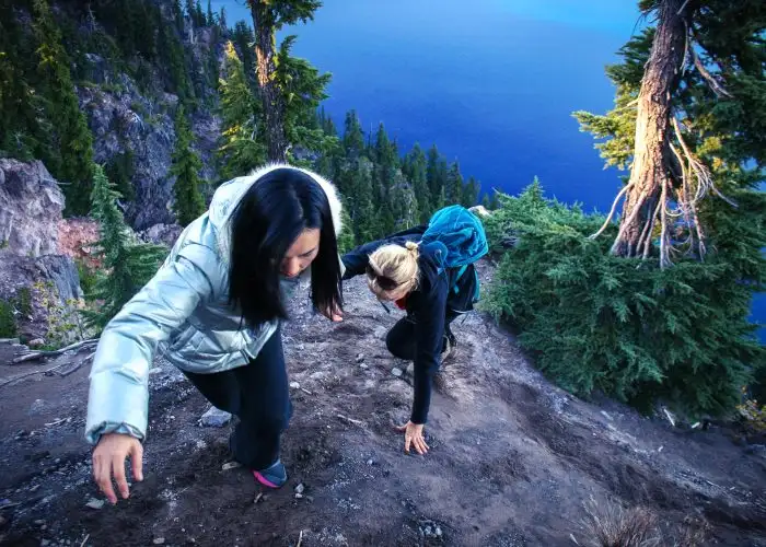 two girls climbing mountain