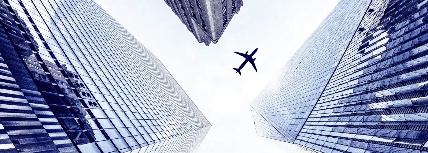 airplane over skyscrapers