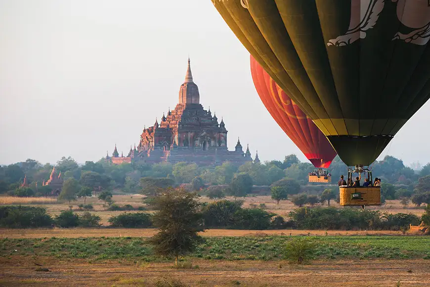 Hot air balloons fly over Bagan, that always recognised as amazing buddhism landmark. 