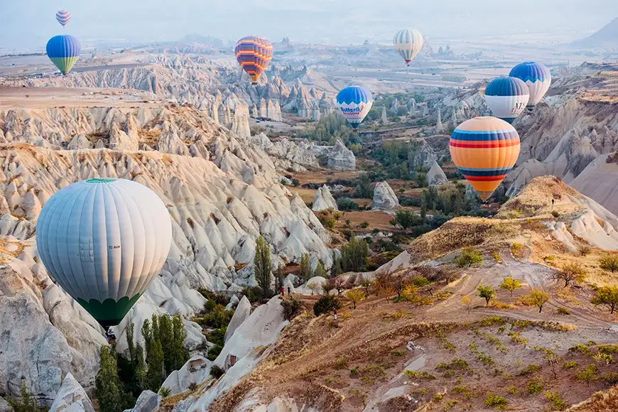 view of hot air balloons flying over the Valley of Love in Cappadocia 