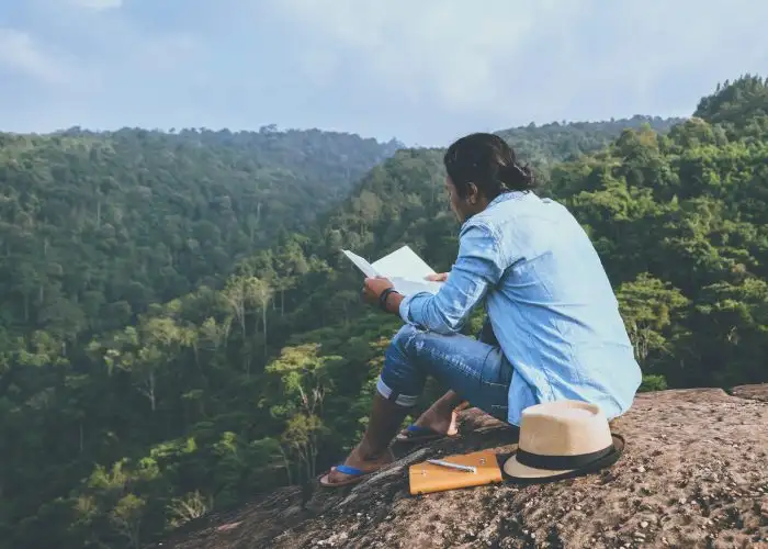 traveler reading a book outdoors
