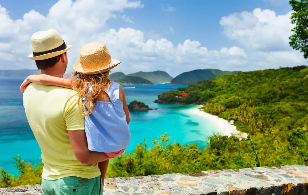 Man carrying child looking at beach in usvi