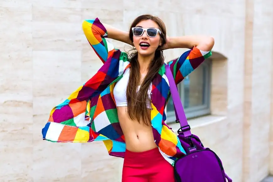 woman in bright colored shirt and purple bag.