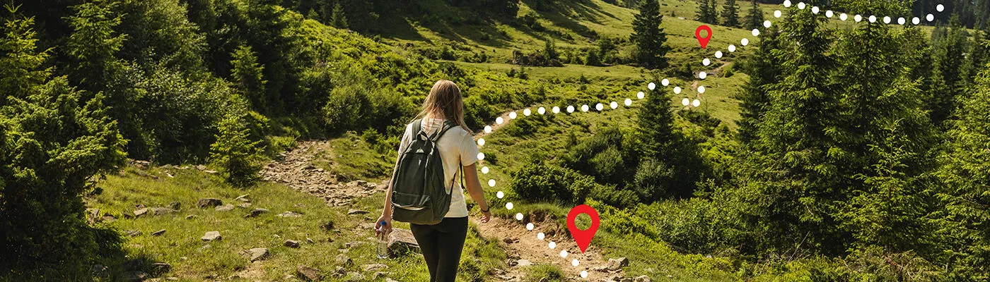 Woman following an overlayed GPS path on a hiking trail