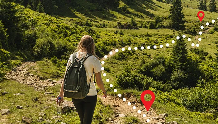 Woman following an overlayed GPS path on a hiking trail