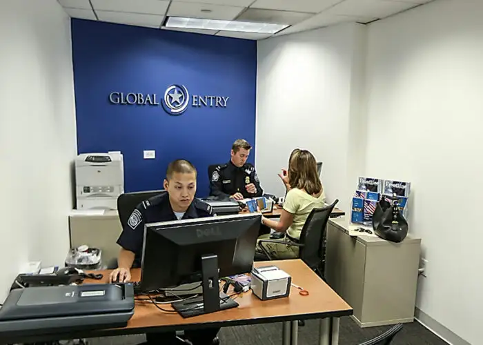A CBP officer collects information from an enrollee during a Global Entry interview at the Ronald Reagan building.