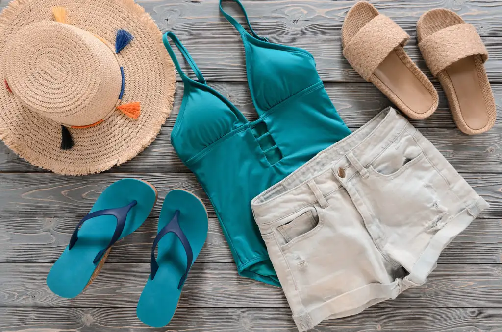 Beach clothing laid out on wooden backdrop