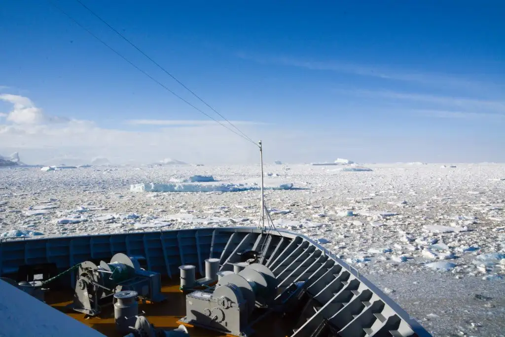 Boat in front of pack ice sheet antarctica