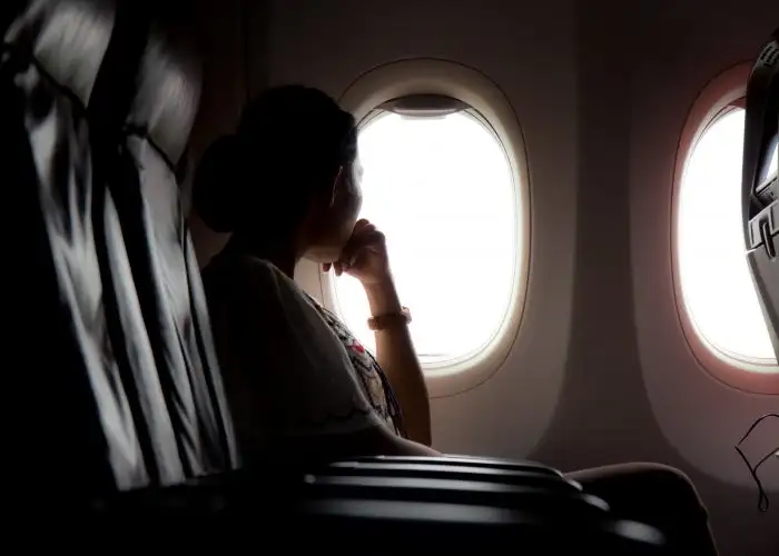 woman on plane looking out window