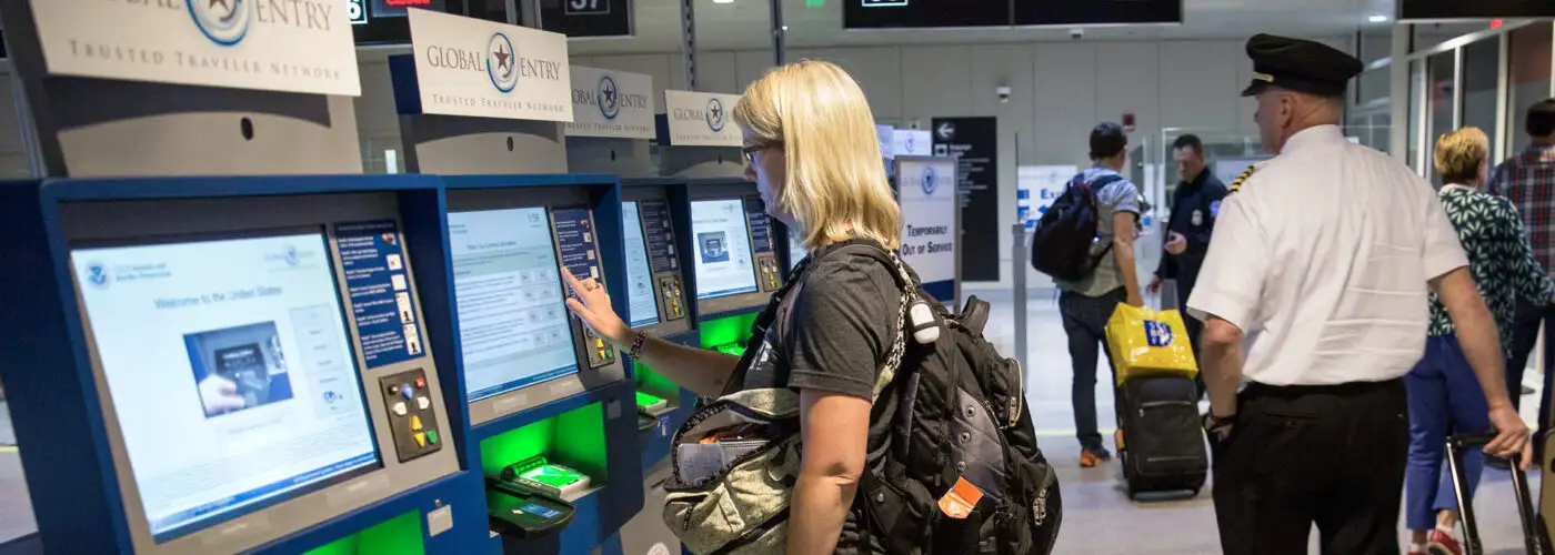 woman at global entry kiosk in Boston airport.