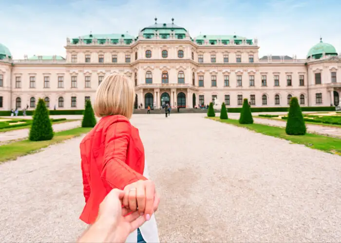 young woman pulling hand belvedere vienna austria.