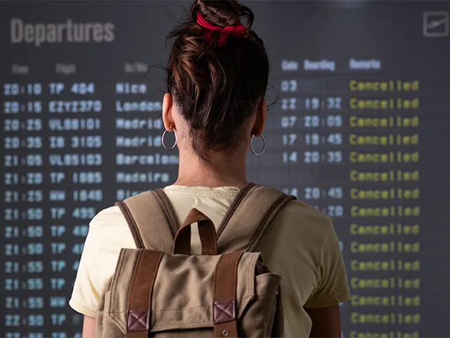 Woman reading arrivals board at airport