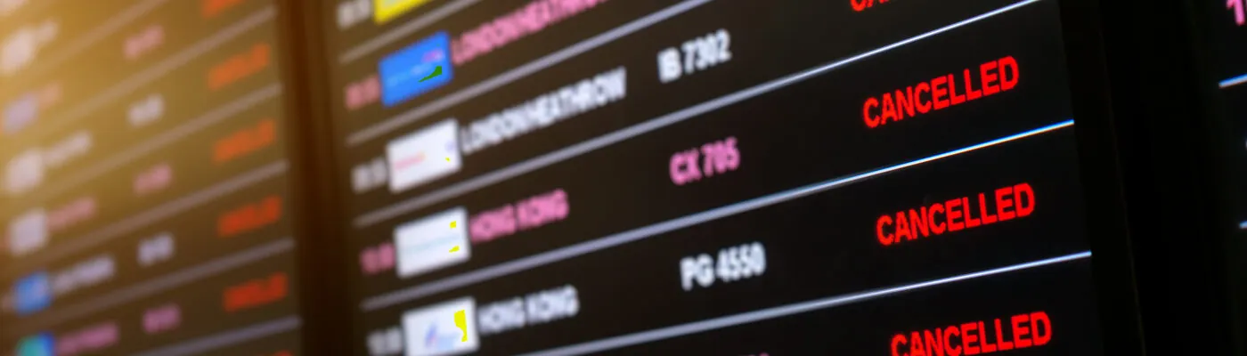 Arrivals board showing cancelled flights at airport