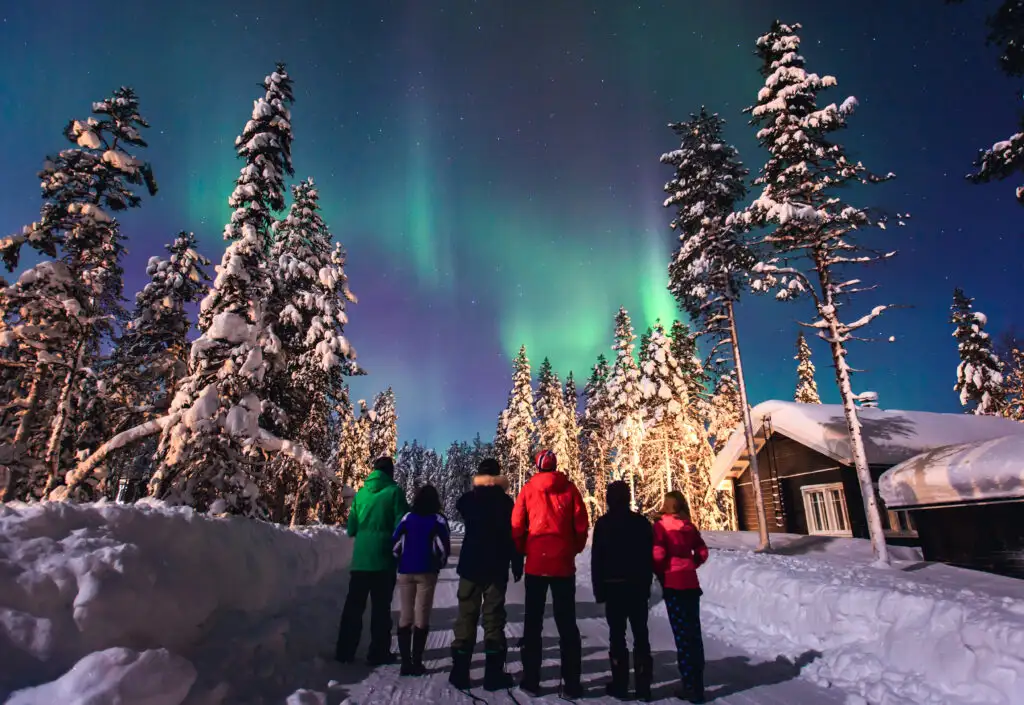 group of people viewing the northern lights in norway