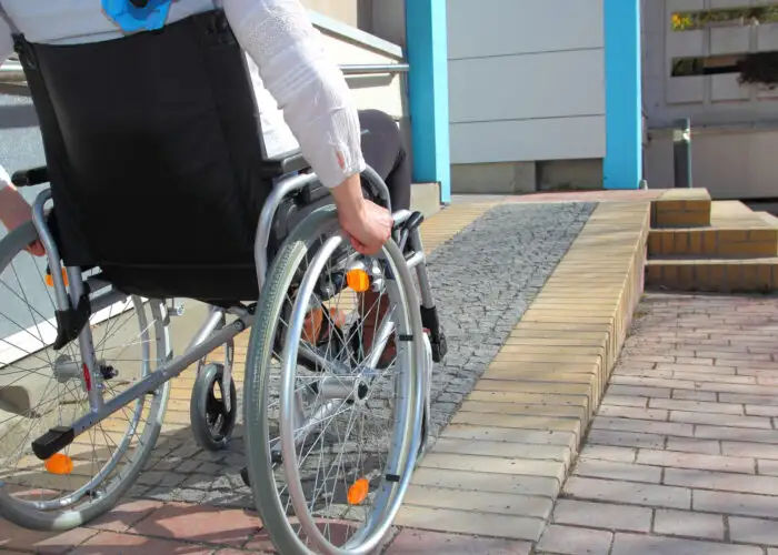 woman in wheelchair using ramp.