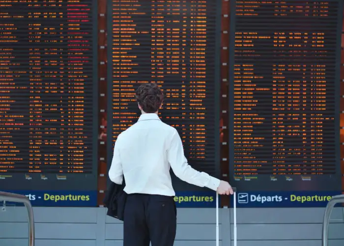 Man looking at departures board at airport