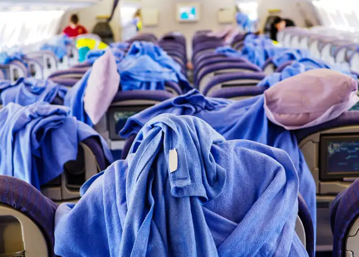 Pillows and blankets on economy class of commercial airlines, waiting to be cleaned after the aircraft arrived to the destination