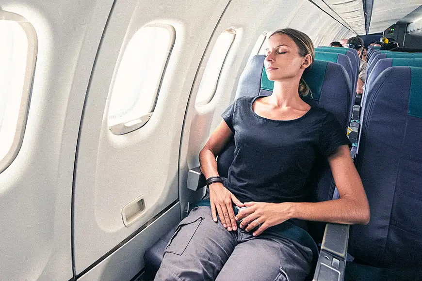woman reclining seat flight plane window