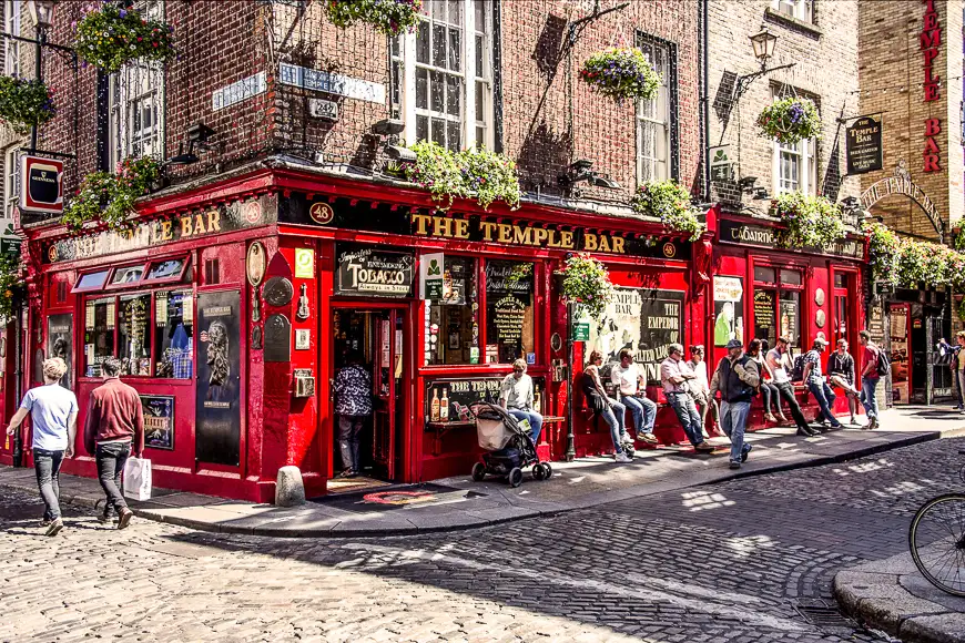 People relax and have a drink outside the famous Irish pub The Temple Bar in the center of the Irish capital