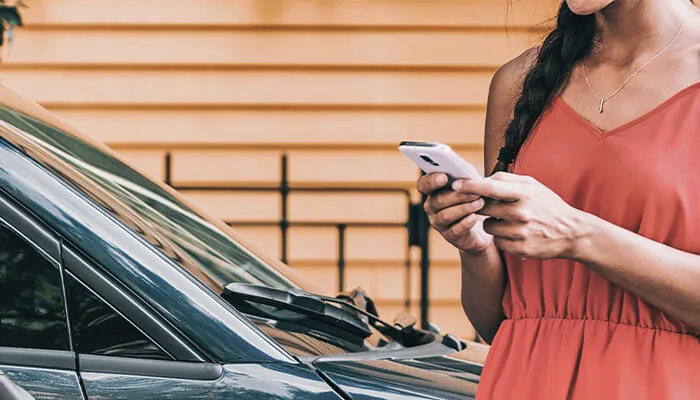 Woman calling a rideshare on her smartphone