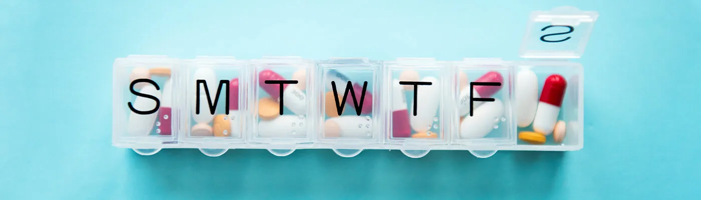 Pill organizer on a blue background