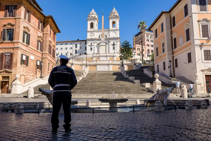 A Police stands alone in front of the Spanish Steps in Rome, Italy