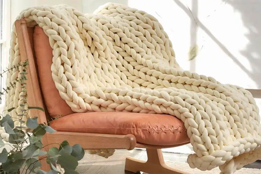 yaasa weighted blanket draped across a chair.