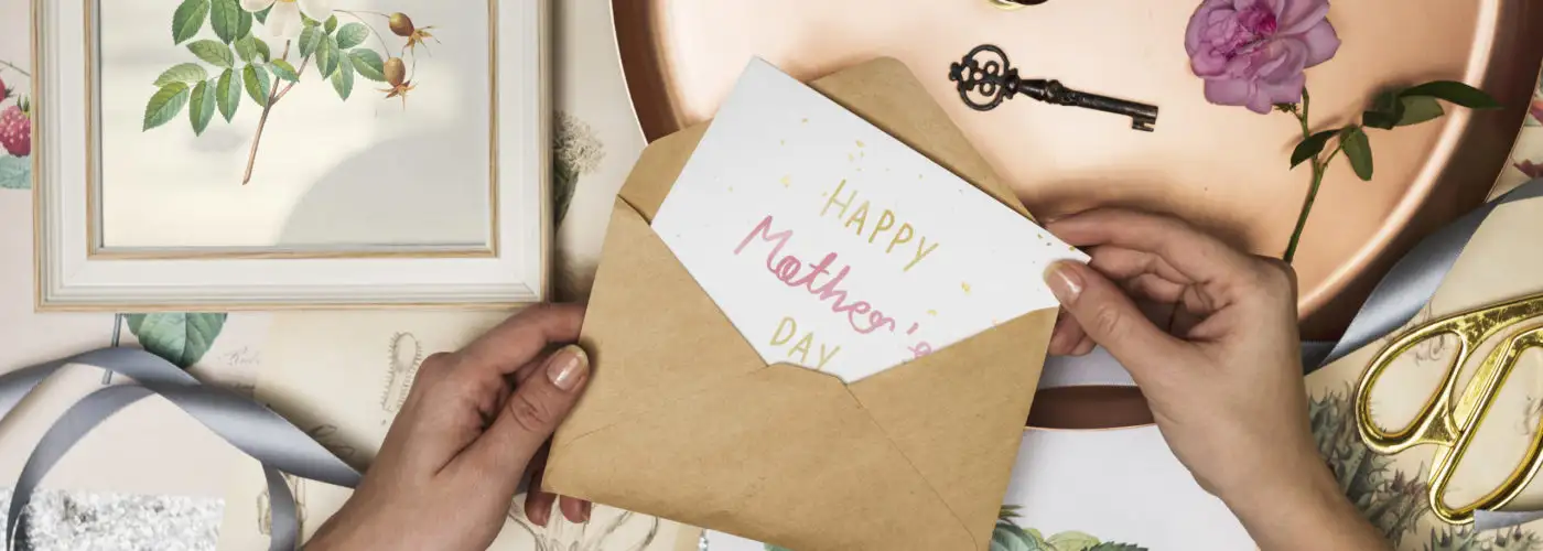 Hands opening a Mother's Day card