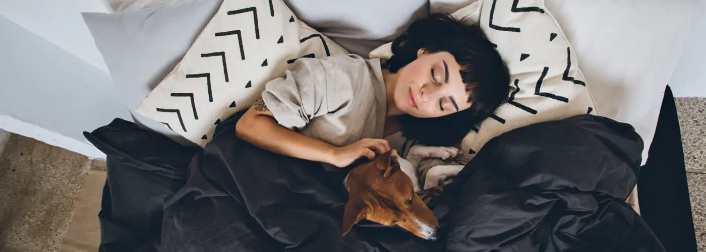 woman and dog in bed.