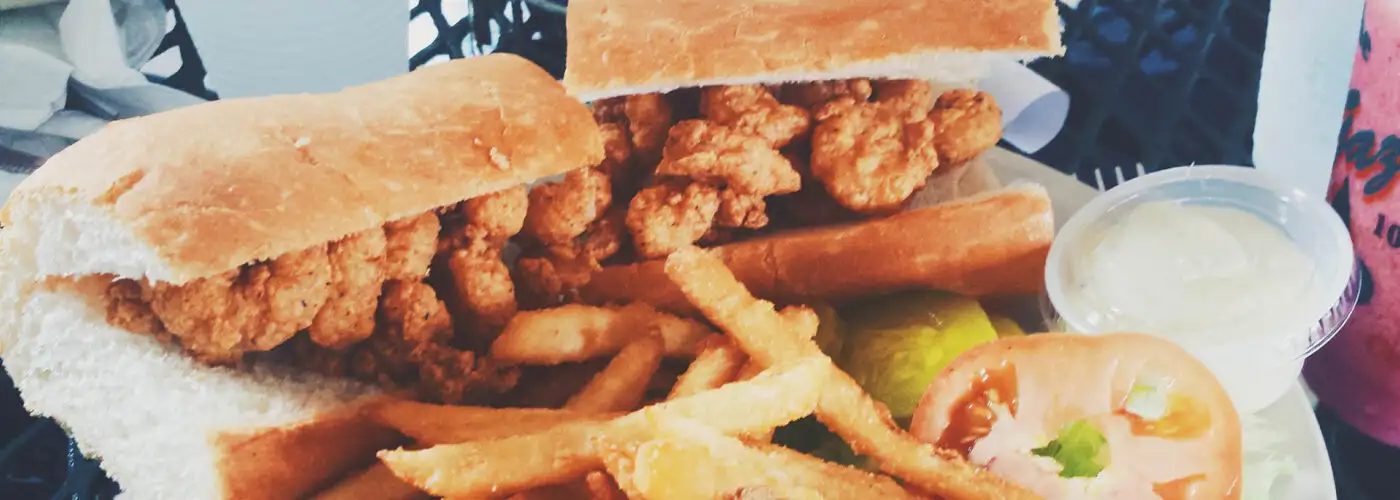 new orleans po-boy sandwich and fries.