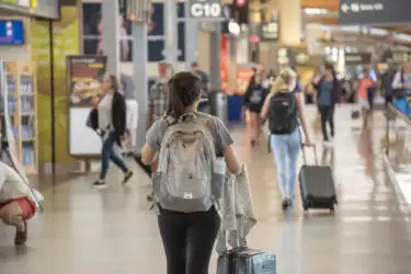 Girl pulling luggage through airport