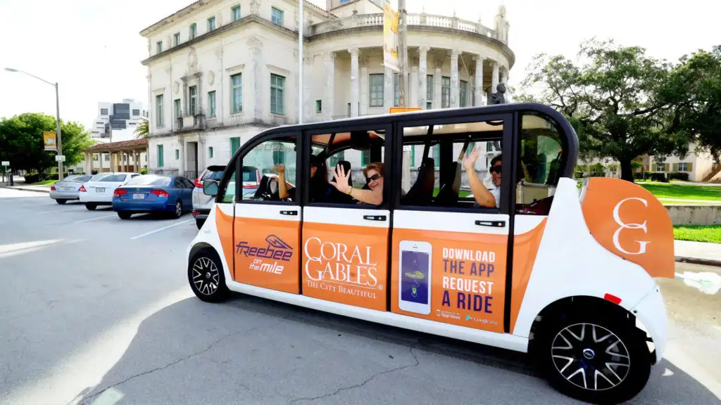 Tourists being driving in a golf buggy from Freebie driver service in Miami