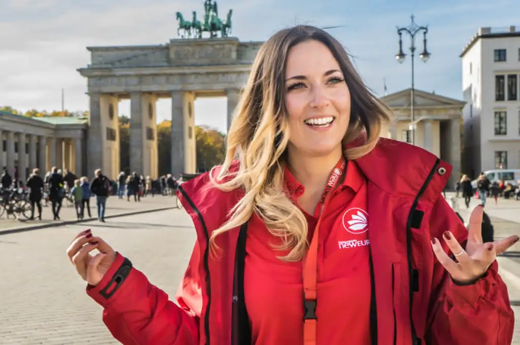 Woman in red jacket giving at walking tour in Germany