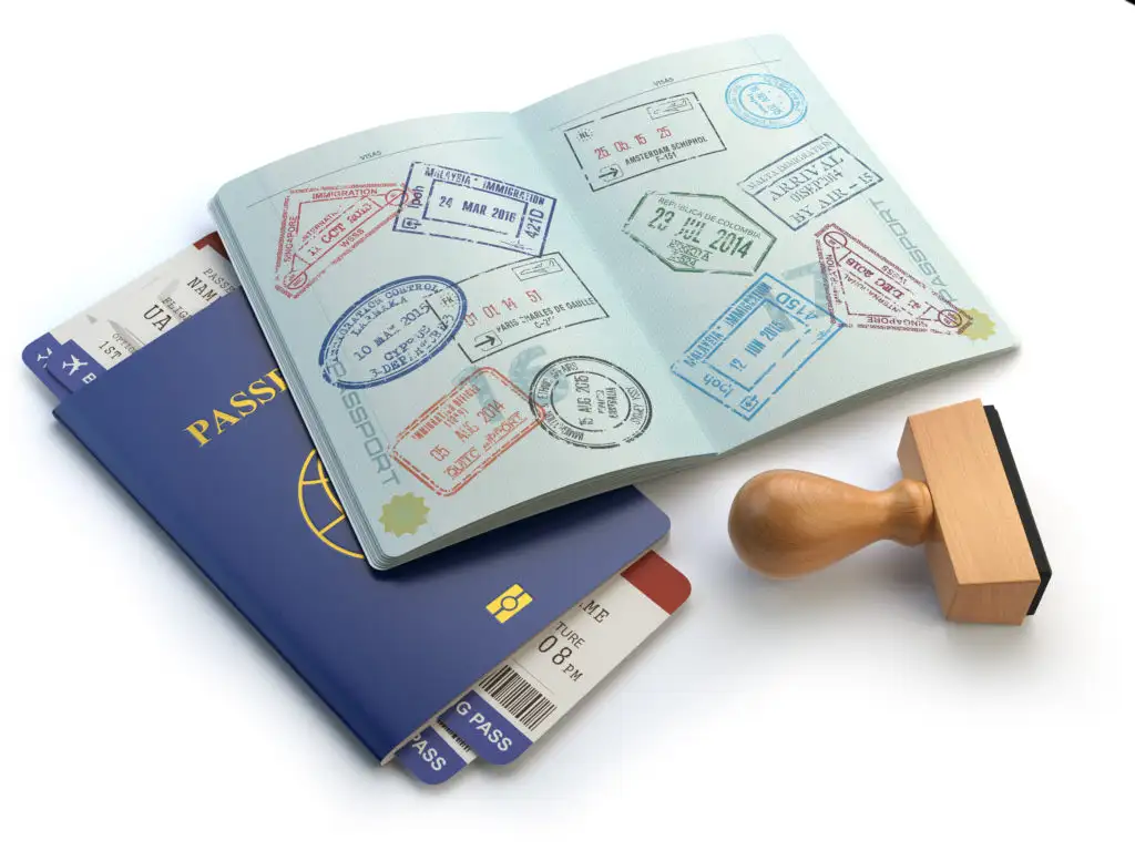 Open passport book, closed passport book, passport stamp, and two airplane boarding passes