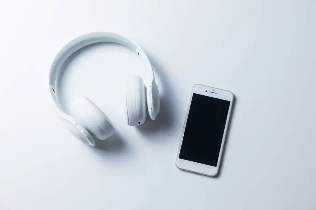 Wireless headphones and smartphone on a white background