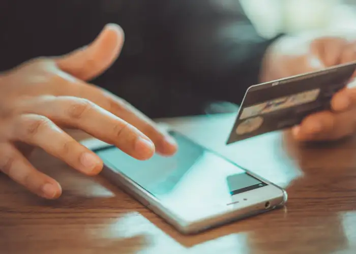 Person making a credit card purchase on smartphone